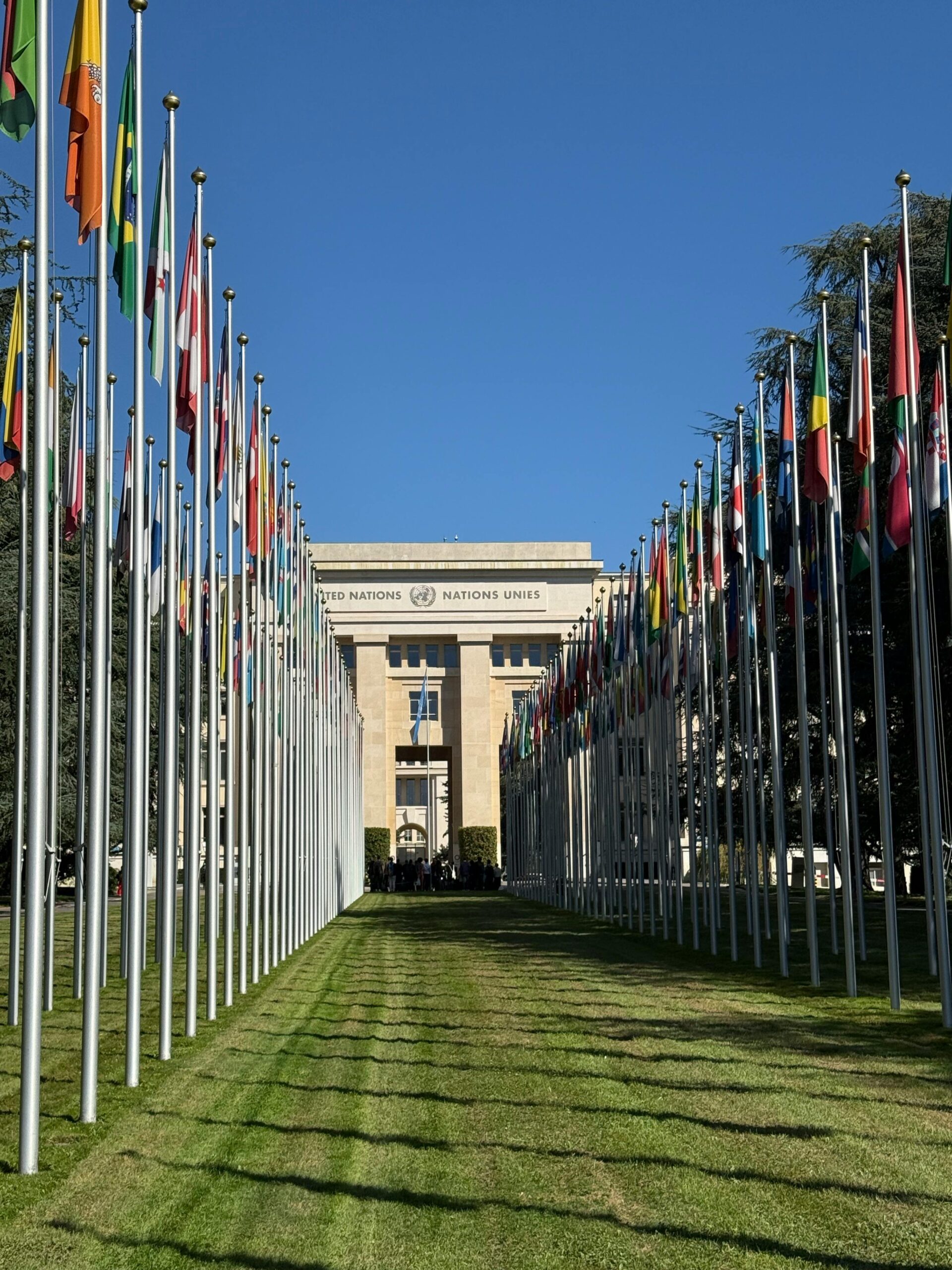 Flags line the pathway to the United Nations building in Geneva, Switzerland on a sunny day.